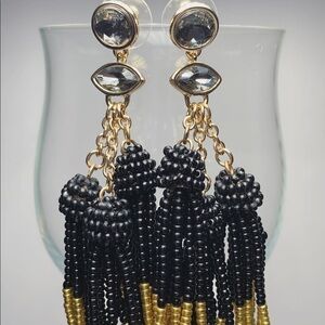 Gold and black dangling BP earrings